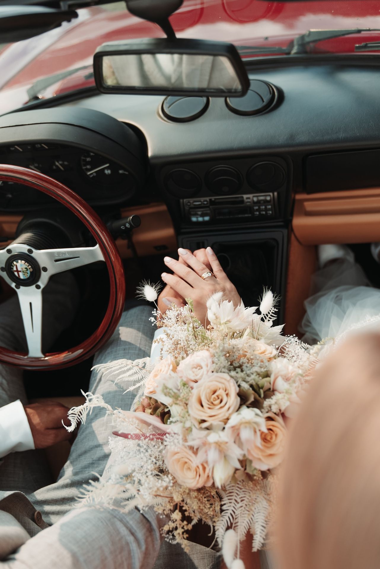 a person holding flowers in a car